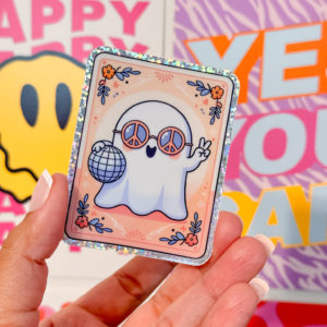 A holographic ghost in groovy sunglasses, holding a disco ball with the peace sign up in a tarot card style