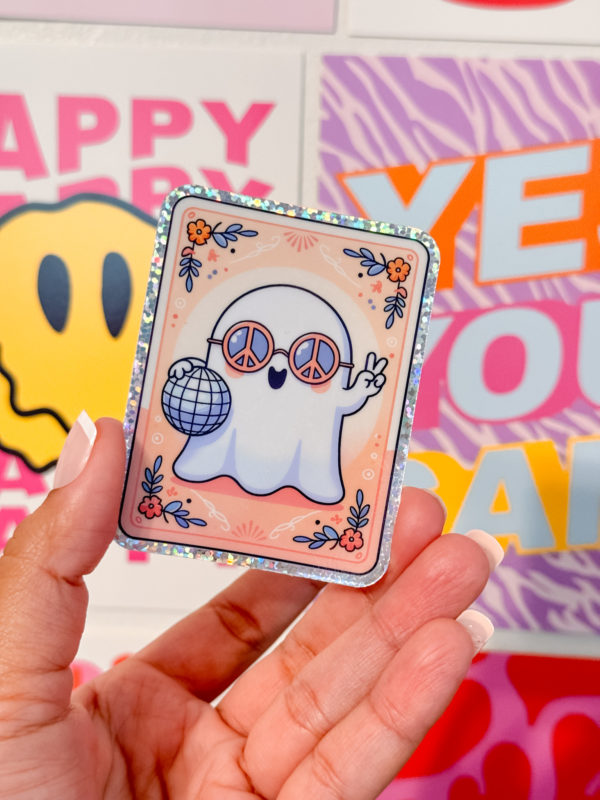 A holographic ghost in groovy sunglasses, holding a disco ball with the peace sign up in a tarot card style