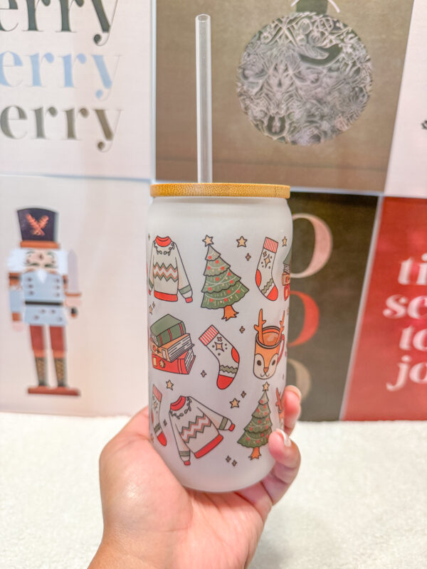 Sip your favorite holiday beverages in style with this 16oz frosted glass can featuring a cozy and festive design! Adorned with a sweater, Christmas tree, books, stockings, and reindeer, this cup is perfect for anyone who loves the warm and fuzzy vibes of the holiday season.