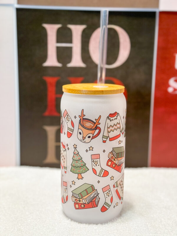 Sip your favorite holiday beverages in style with this 16oz frosted glass can featuring a cozy and festive design! Adorned with a sweater, Christmas tree, books, stockings, and reindeer, this cup is perfect for anyone who loves the warm and fuzzy vibes of the holiday season.