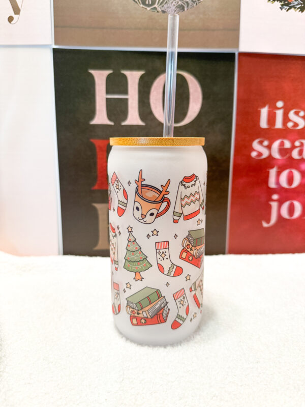 Sip your favorite holiday beverages in style with this 16oz frosted glass can featuring a cozy and festive design! Adorned with a sweater, Christmas tree, books, stockings, and reindeer, this cup is perfect for anyone who loves the warm and fuzzy vibes of the holiday season.